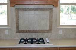 Granite countertops with a custom tiled backsplash.